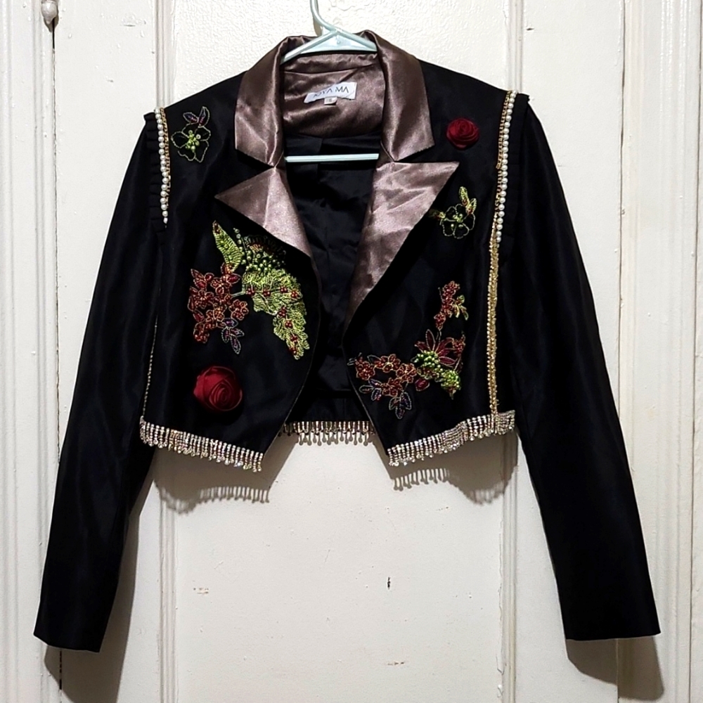 Beautiful bolero jacket with ruffles and pearls on shoulder.